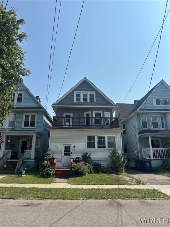 93 Lockwood Ave, Buffalo, NY 14220 - view of front of home with a balcony, a porch, and a front lawn