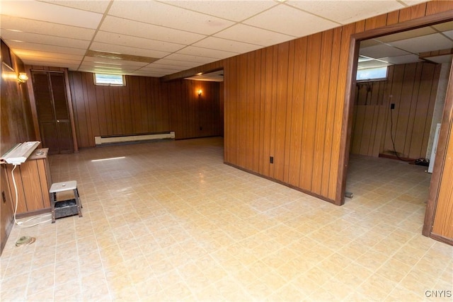 209 Pear Tree Dr, Camillus, NY 13031 - below grade area with wood walls, light flooring, a drop ceiling, and a baseboard radiator