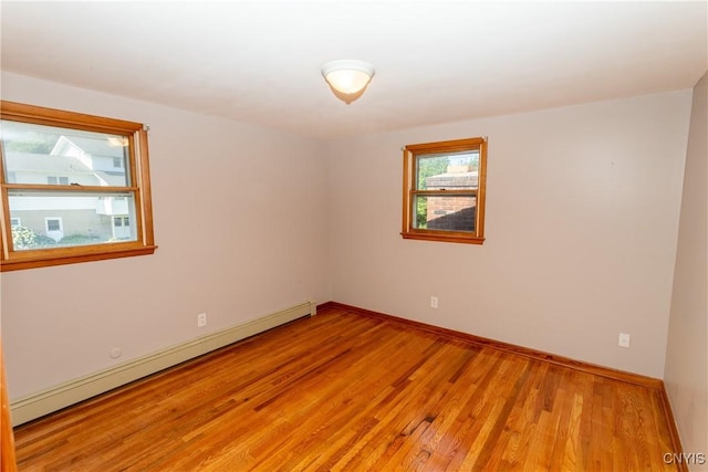 209 Pear Tree Dr, Camillus, NY 13031 - spare room featuring baseboard heating and light wood-style floors