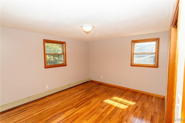 209 Pear Tree Dr, Camillus, NY 13031 - spare room featuring baseboard heating and light wood-type flooring