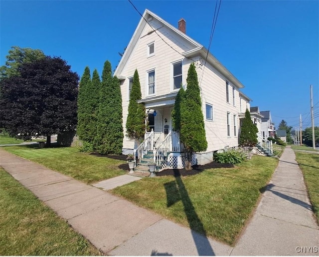 802 State St, Wilna, NY 13619 - view of front of house featuring a chimney and a front lawn