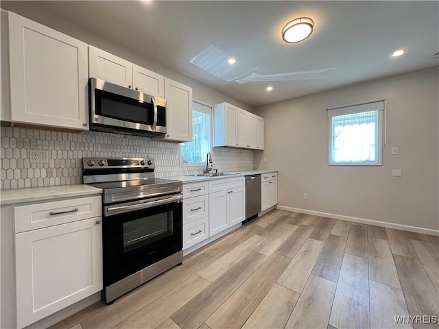 42 Argus St, Buffalo, NY 14207 - kitchen featuring stainless steel appliances, plenty of natural light, light countertops, light wood finished floors, and recessed lighting