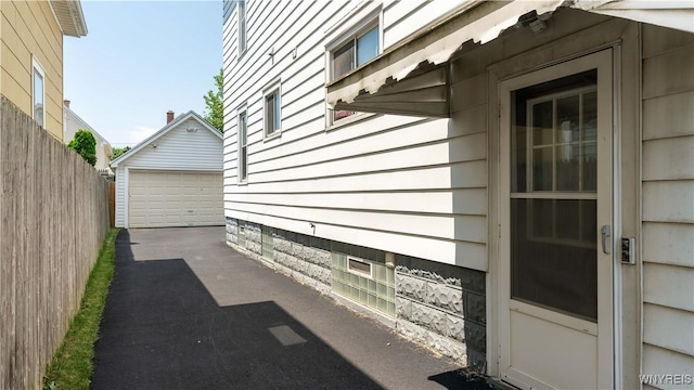 46 Alexander Ave, Cheektowaga, NY 14211 - view of property exterior featuring an outdoor structure and a detached garage