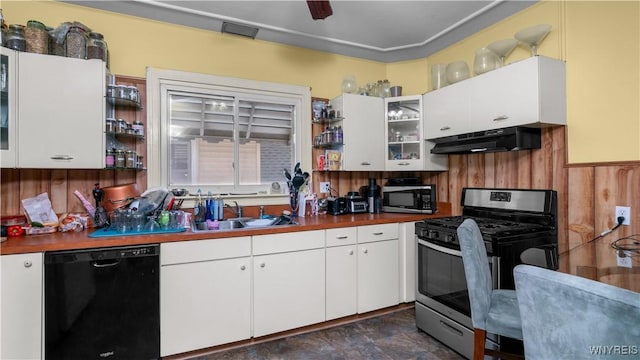 46 Alexander Ave, Cheektowaga, NY 14211 - kitchen featuring stainless steel appliances, under cabinet range hood, white cabinets, wooden walls, and dark countertops
