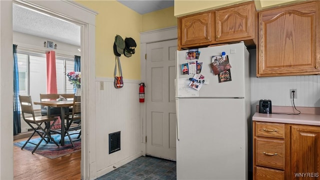 46 Alexander Ave, Cheektowaga, NY 14211 - kitchen featuring freestanding refrigerator, a wainscoted wall, and light countertops