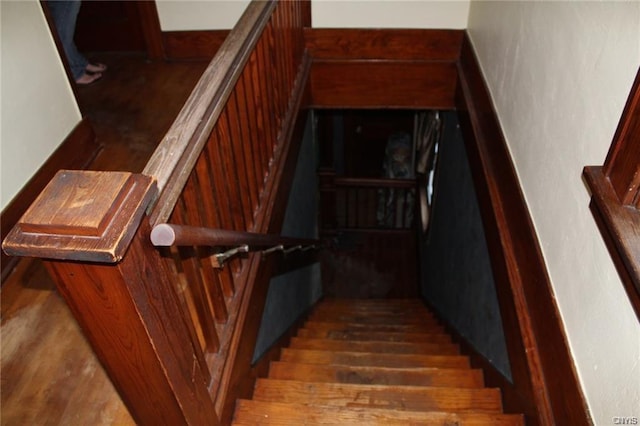 stairway with dark wood-type flooring