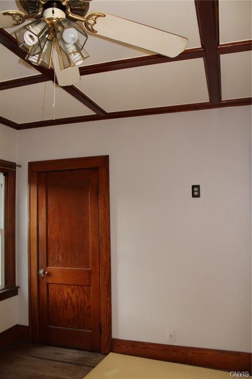 unfurnished room featuring ceiling fan and dark hardwood / wood-style floors