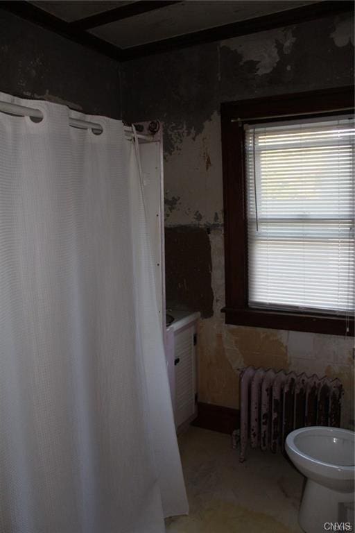 bathroom featuring toilet and radiator