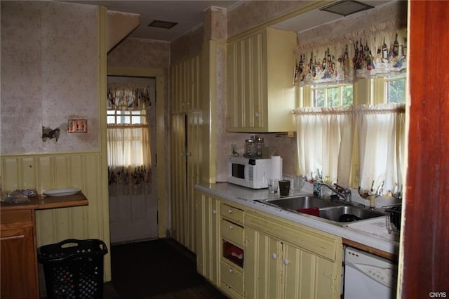 kitchen featuring plenty of natural light, white appliances, and sink