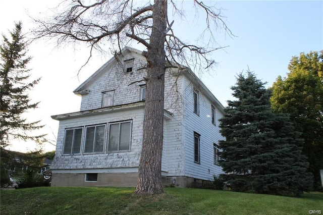 view of side of home featuring a lawn