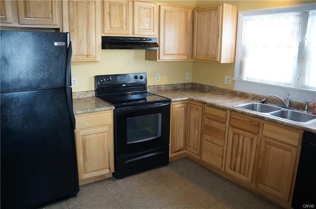 kitchen with light tile floors, light brown cabinetry, black appliances, and sink