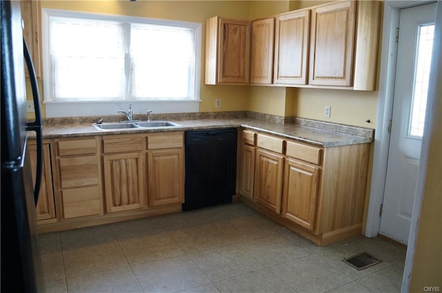 kitchen featuring light tile floors, black appliances, and sink