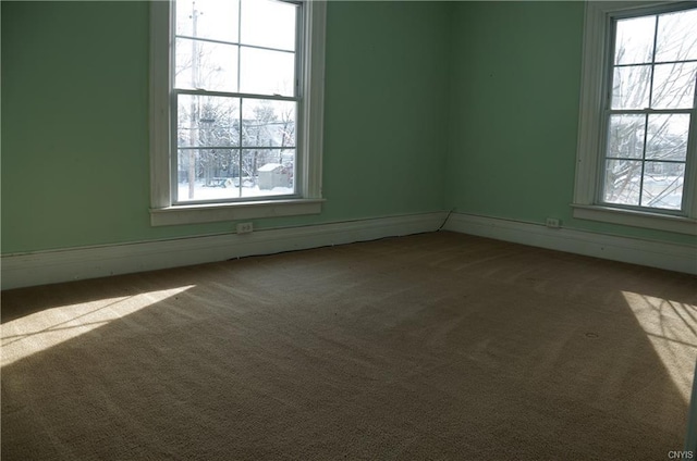 carpeted empty room featuring plenty of natural light