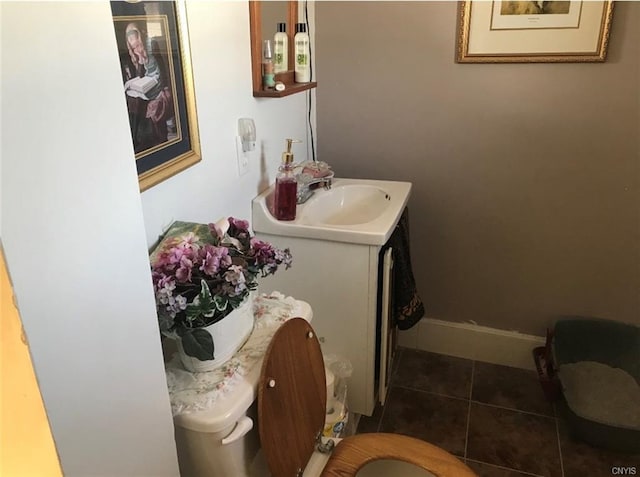 bathroom featuring tile floors, toilet, and vanity