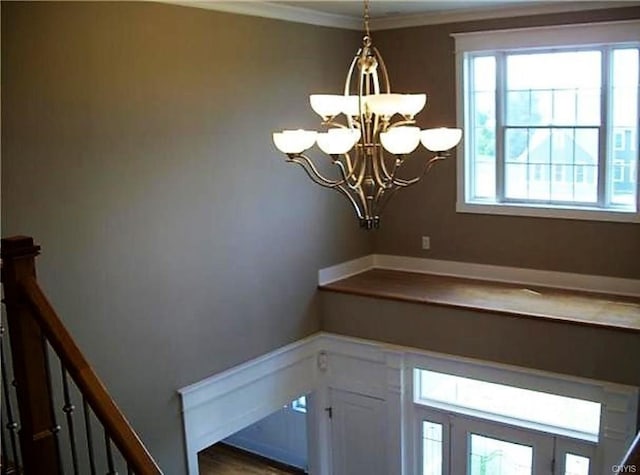 room details featuring a notable chandelier and crown molding