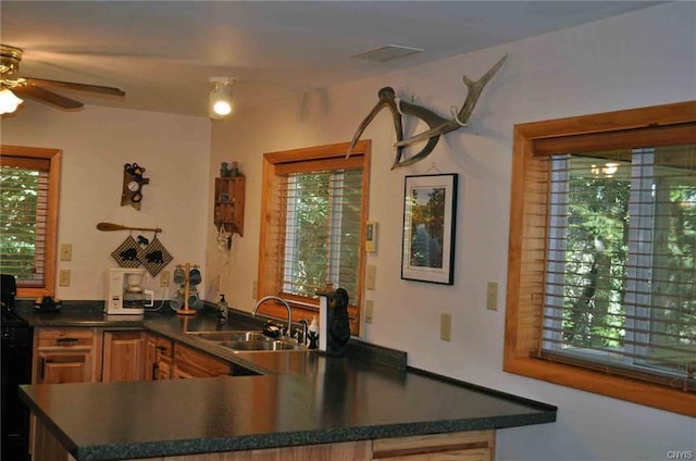 kitchen featuring ceiling fan, sink, and kitchen peninsula