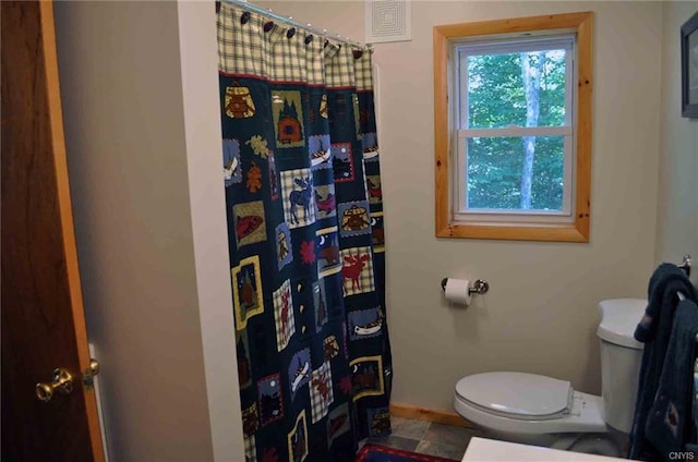 bathroom featuring toilet and tile flooring