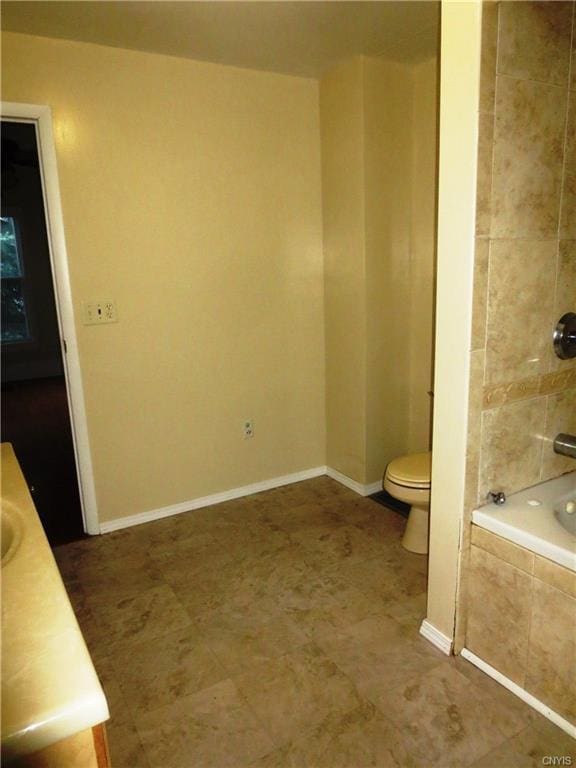 bathroom featuring toilet, tile flooring, and vanity