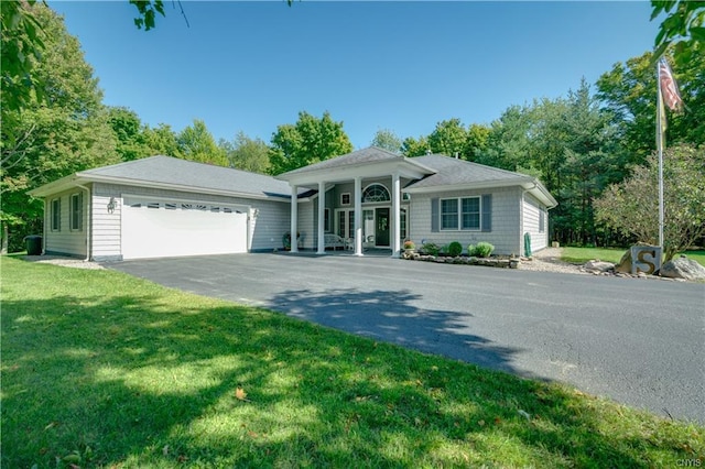 ranch-style house featuring a front lawn and a garage