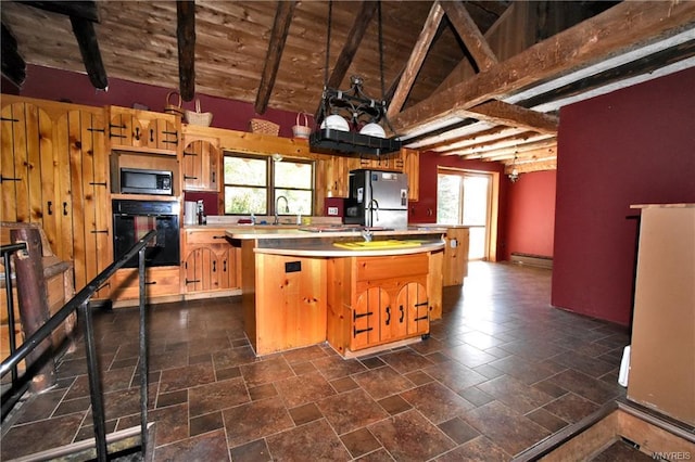 kitchen featuring a center island with sink, dark tile floors, a healthy amount of sunlight, and stainless steel appliances