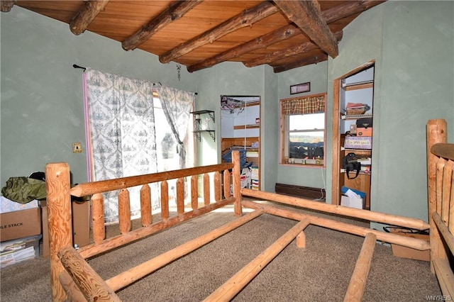 interior space featuring carpet flooring, wood ceiling, and beamed ceiling