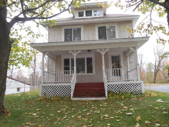 view of front of home with a front yard and a porch