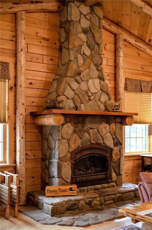 details featuring wooden ceiling, wood walls, beamed ceiling, wood-type flooring, and a fireplace