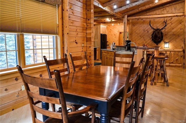 dining room featuring wood walls, billiards, and light wood-type flooring