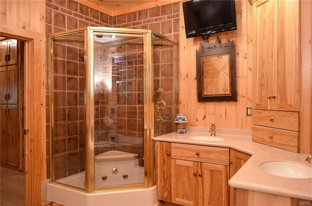 bathroom featuring hardwood / wood-style flooring, an enclosed shower, and oversized vanity