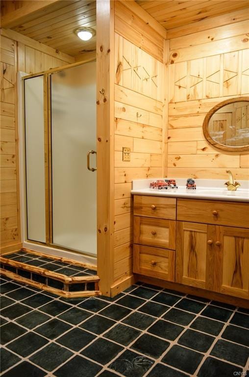 bathroom with an enclosed shower, vanity, tile floors, wooden walls, and wood ceiling