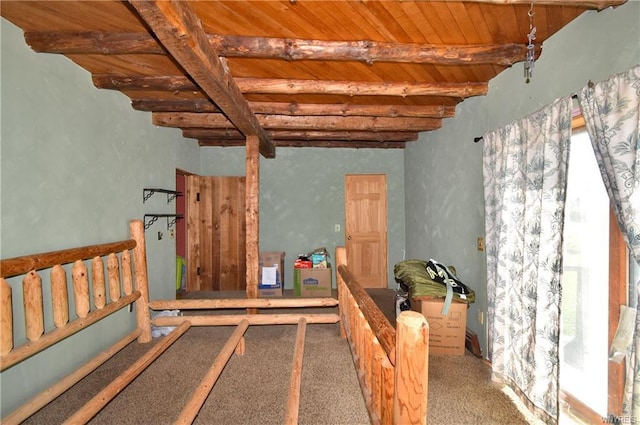 interior space with wooden ceiling and dark colored carpet