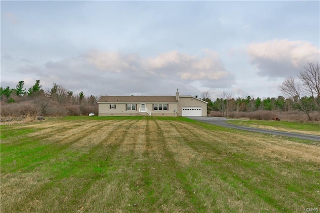 ranch-style house with a front lawn and a garage