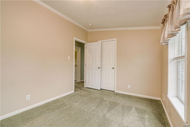 carpeted spare room with crown molding