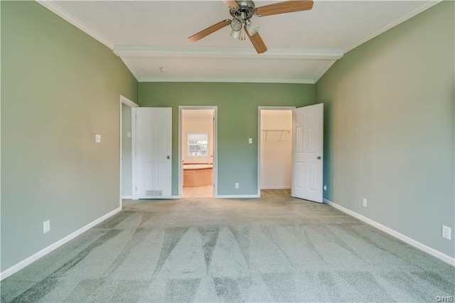 unfurnished bedroom with light colored carpet, a spacious closet, a closet, ceiling fan, and lofted ceiling