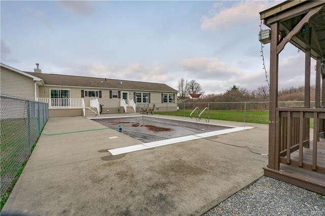 view of pool with a wooden deck and a yard