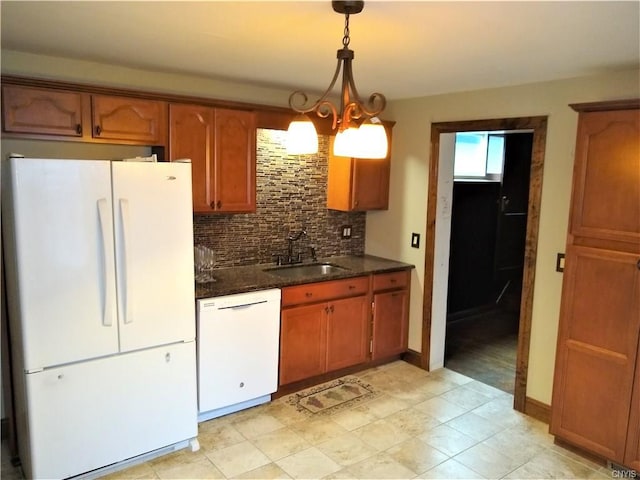 kitchen featuring pendant lighting, an inviting chandelier, tasteful backsplash, white appliances, and sink