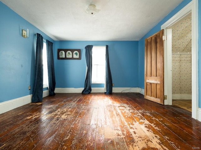 spare room with dark hardwood / wood-style flooring