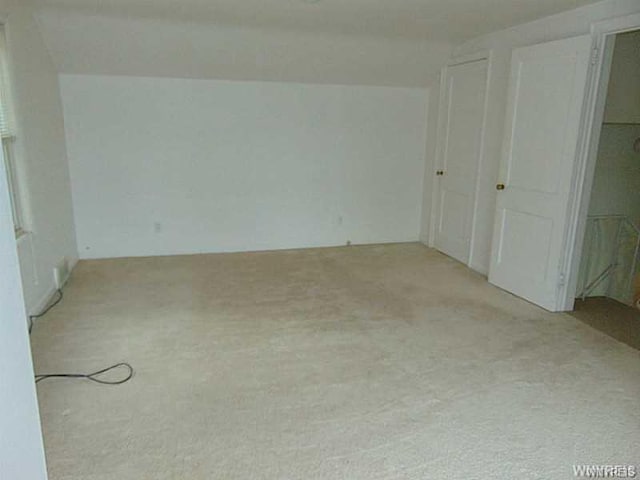 unfurnished bedroom featuring light colored carpet