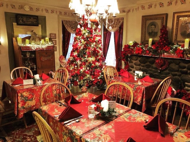 dining area with ornamental molding and an inviting chandelier