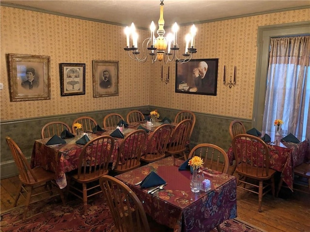 dining area featuring an inviting chandelier, dark hardwood / wood-style flooring, and ornamental molding