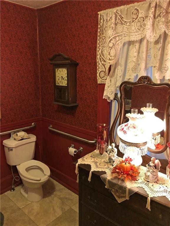 bathroom with toilet, tile flooring, and vanity