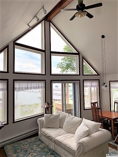 interior space with beam ceiling, high vaulted ceiling, ceiling fan, and rail lighting