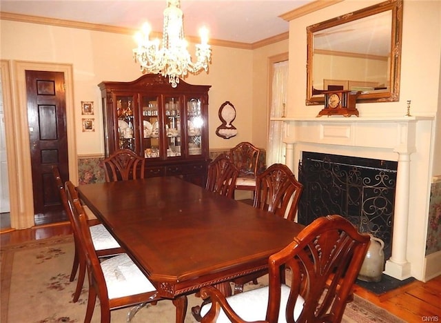 dining space featuring a notable chandelier, ornamental molding, and hardwood / wood-style floors