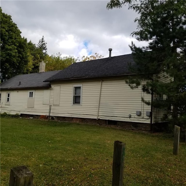 view of side of property with a yard