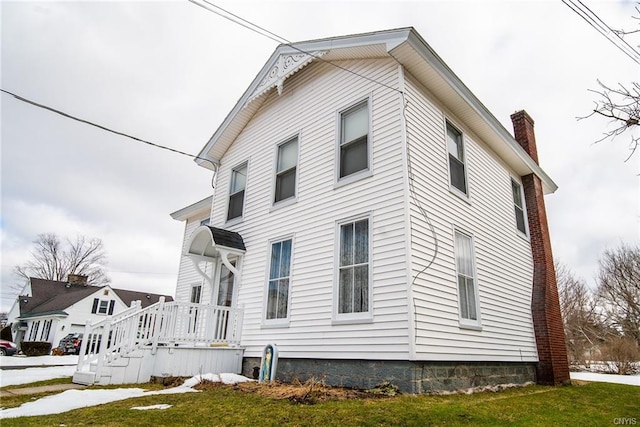 view of side of property with a yard