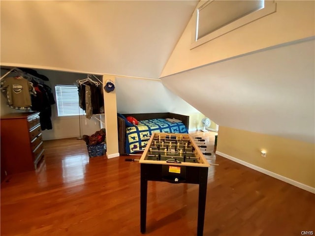 bedroom with dark hardwood / wood-style flooring and vaulted ceiling