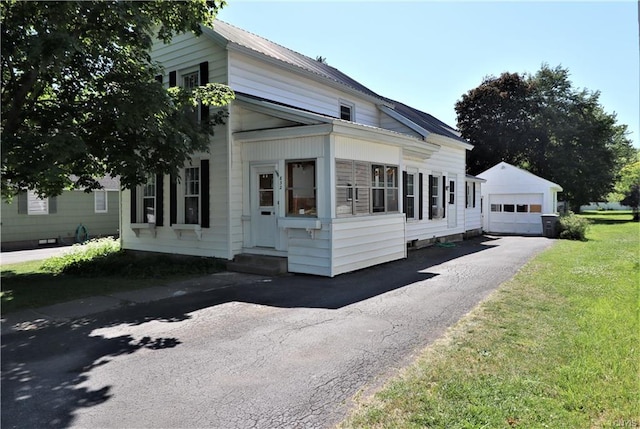 view of side of property with a yard and a garage