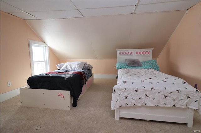 bedroom featuring light colored carpet and vaulted ceiling