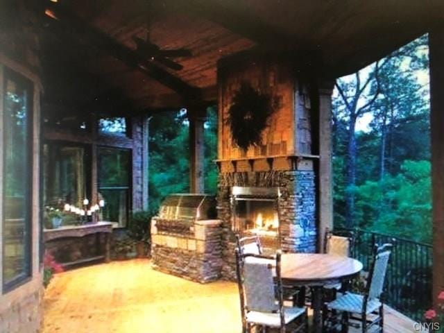 view of patio with a stone fireplace