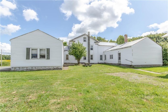 back of house featuring a lawn